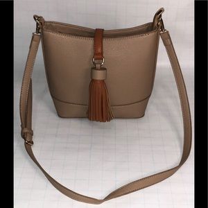 Beige crossbody leather tote with brown tassel